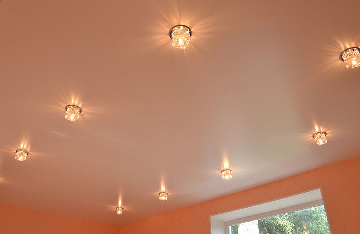 Персиковый сатиновый натяжной потолок со светильниками
